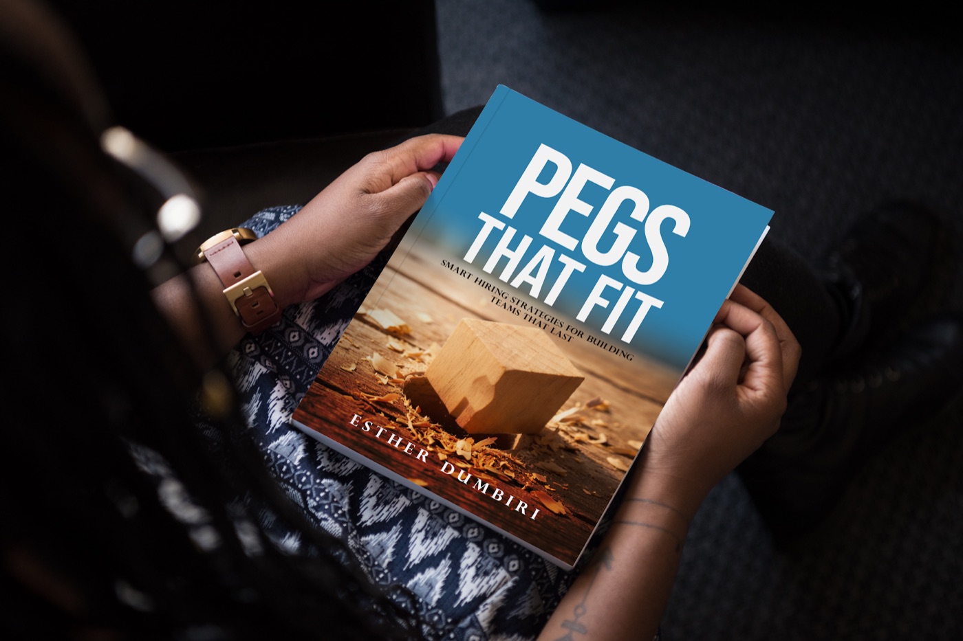 A reader holding Pegs That Fit