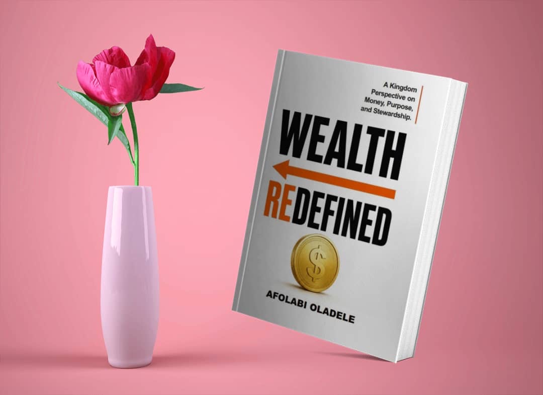 Wealth Redefined beside a vase